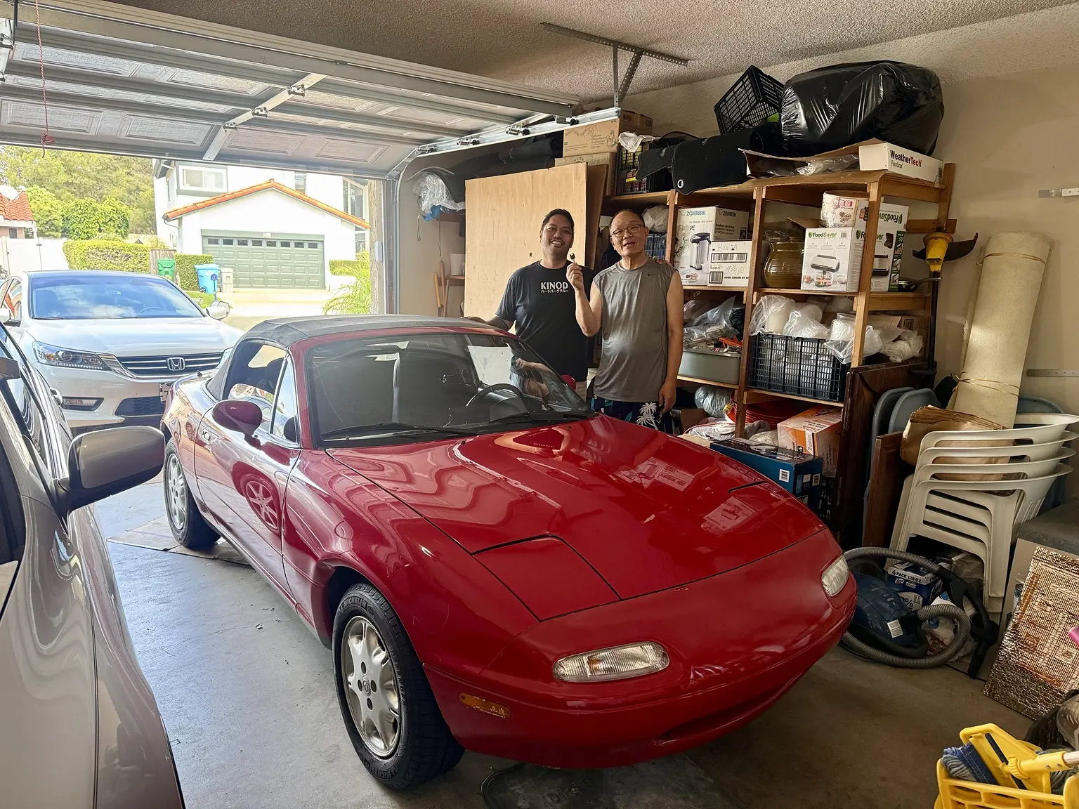 The Miata handoff in the family garage