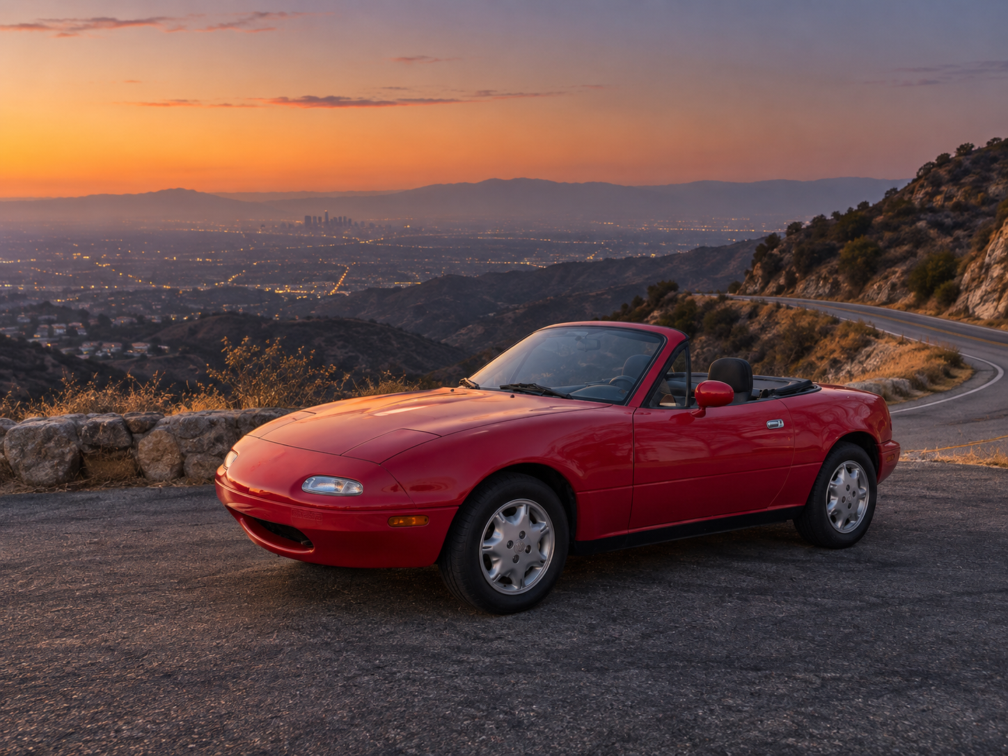 Stock classic-red roadster with its top down at a Southern California overlook